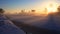 Sunrise at beautiful morning shining on frozen canal in Dutch winter landscape