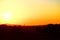 sunrise behind a single old chimney in rural landscape