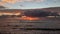 Sunrise at black reef covered with seaweed in winter in Kapaa on Kauai Island, Hawaii.