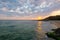 sunrise at the black sea. wonderful calm landscape with rocks on the beach beneath a cloudy sky