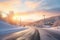 sunrise casting glow on snowy hillside road