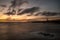 Sunrise at a chilly Cullercoats Bay in the north east of England, with Tynemouth Pier and the lighthouse in the distance