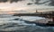 Sunrise at a chilly Cullercoats Bay in the north east of England, with Tynemouth Pier and the lighthouse in the distance