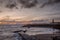 Sunrise at a chilly Cullercoats Bay in the north east of England, with Tynemouth Pier and the lighthouse in the distance