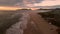 Sunrise with clouds and beach in Campeche, Florianopolis, Brazil. Aerial view