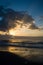 Sunrise with Clouds and Beams of Light Over the Beach and Ocean