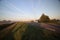 Sunrise with colored aircraft trails, fog on the meadows and at River Hollandsche IJssel