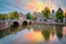 Sunrise colors in Amsterdam. Panoramic views of the famous old houses, the bridge and the canal in the downtown. Amsterdam,