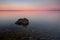 Sunrise Croatia Beach with Pastel Color sky and Rock in Foreground