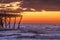 Sunrise and The damaged fishing pier on Pawley\\\'s Island, South Carolina