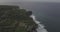 Sunrise drone footage of a calm cliff and beach near Uluwatu temple, Bali, Indonesia