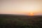 Sunrise on the empty field in the morning mist