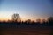 Sunrise in field with a cloudy sky