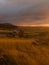 Sunrise in the fields of Easter Island with a tipical house and a volcano in the back