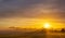 Sunrise with fog in a field with carob trees