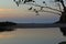 Sunrise with golden, grey and blue reflections on the water. Itamambuca beach