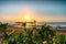 Sunrise with green plants in the foreground and a Balinese pavilion?  Sanur, Bali