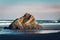 Sunrise hitting a rock on the beach