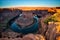 Sunrise at Horseshoe Bend on Colorado River in Glen Canyon, Ariz