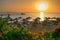 Sunrise on the idyllic beach with palms and sun umbrelas, Red Sea, Egypt