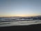 Sunrise illuminating the morning waves at the beach