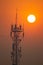 Sunrise illuminating a radio base station, with a bright sky in the background.