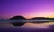 Sunrise at La Concha beach with Mount Urgull and the city of Donostia in the background.