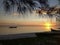 The sunrise on the lagoon with trees, sand and a water mirror. In Praia Seca, Rio de Janeiro, Brazil.