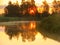 Sunrise by the lake. the mist rises above the water, the foreground of the lake blurred