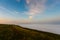 Sunrise landscape. Early morning slopes covered with heavy fog