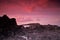 sunrise landscape with lava rock and red sky background