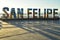 Sunrise light behind three-dimensional letters sign town San Felipe, Baja, Mexico