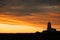 Sunrise lighthouse silhouette.