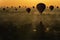 Sunrise many hot air balloon in Bagan. Hot air balloon over plain of Old Bagan in misty morning. Bagan is an ancient with many
