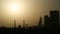 Sunrise in the morning in Dubai. Silhouettes of buildings and Moslem mosque.