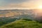 Sunrise upon on mountain range and alpine meadow