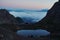 Sunrise in the mountains, Ausrtian Alps view shelter on peack. Pinky sky with clouds, mirroring in lake. Area for hiking and Via