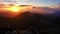 Sunrise in the mountains, clouds spill over the peaks of hills in the Carpathian mountains,timelapse