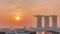 Sunrise near Marina Bay Sands Hotel dominates the skyline at Marina Bay in Singapore aerial timelapse.