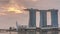 Sunrise near Marina Bay Sands Hotel dominates the skyline at Marina Bay in Singapore timelapse.