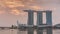 Sunrise near Marina Bay Sands Hotel dominates the skyline at Marina Bay in Singapore timelapse.