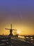 Sunrise with the Neowise comet obove Kinderdijk windmills