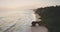 Sunrise at ocean cliff shore with giant hole at rock wall aerial view. Tropical nature landscape