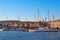 Sunrise in Old Venetian port, Chania, Crete, Greece. Sailing boats, yachts, pier, Old Venetian shipyard. Bell tower of