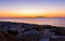 Sunrise over Aegean Sea seen from Kamari village street Santorini Greece