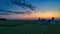 Sunrise over barns and silos