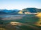 Sunrise over blooming cultivated fields, famous colourful flowering plain in the Apennines, Castelluccio di Norcia highlands,