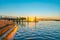 Sunrise over blue water of Tauranga harbour with intense golden glow on horizon