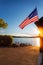 Sunrise over boat ramp and flag