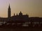 Sunrise over a canal in Venice, with gondolas